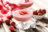 Two glasses of strawberry mousse topped with strawberry slices and mint, placed on a rustic wooden table with fresh strawberries and checkered cloth.