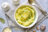 A bowl of creamy mashed potatoes topped with grated cheese and chopped parsley